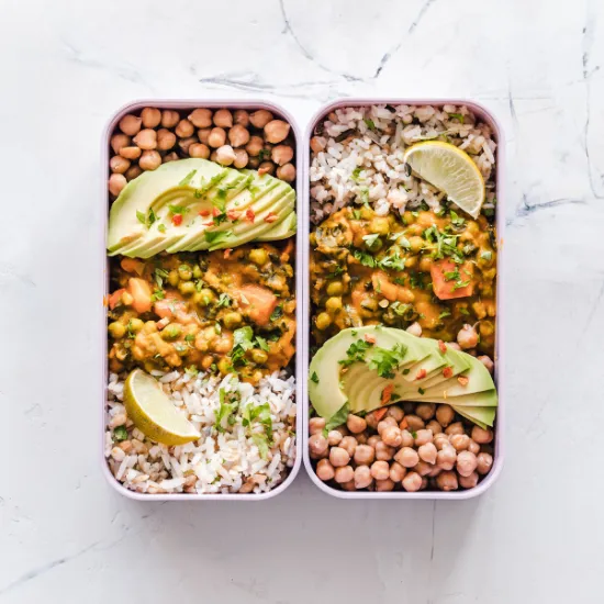 Fresh produce and grains arranged on a surface before preparation.